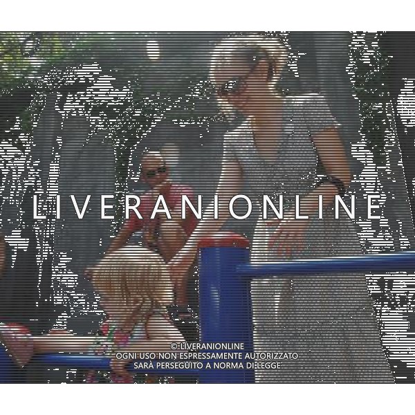 (120314) -- BEIJING, March 14, 2012 () -- The file photo taken on July 19, 2008 shows Johnson-Hill and his wife playing with their daughter in an alley of Beijing, capital of China. The businessman Dominic Johnson-Hill came from Britain. In 1993, when he first arrived in Beijing, the British man never imagined he would stay here for 19 years, run a business and start a family. In 2006, Johnson-Hill opened his own creative T-shirts store \'Plastered 8\' in Nanluoguxiang, an old Beijing style alleyway with a history of over 800 years in the city\'s downtown, with the funds collected in previous market research work. As for T-shirts designing, the most frequent word in his vocabulary is \'idea\'. In his opinion, all of his designing ideas originated from daily life. \'I like collecting second-hand goods with traditional characteristics,\' said Johnson-Hill, \'I adorn T-shirts with patterns, such as early subway ticket and food coupon once used in China. For me, those patterns are symbols of the city from a foreigner\'s eyes.\' Johnson-Hill is not serious about formal design theories. Neither is he restricted by traditional thoughts. He liked to catch those images that locals took for granted, relying on inspiration that flashes across his mind. After years of development, Johnson-Hill has opened branch stores in \'798\' art zone of Beijing and Tianzifang of east China\'s Shanghai. He was at first the only designer of \'Plastered 8\'. Through expansion, he started to cooperate with young creative Chinese designers. \'The development of the country offers more opportunities for young people here to learn designing,\' he said. With the success of \'Plastered 8\', some parallel stores emerged in Nanluoguxiang. The British businessman was tolerant of the competition. He channelled his energy into releasing fresh designs and services. For Johnson-Hill, the father of four children, Beijing means not only \'Plastered 8\' but also as a family. \'Beijing is my family,\' he said. Living in Beijing for 19 years, the British man can speak fluent Chinese. \'I left Britain when I was 17. By now, I stay longer in Beijing than the time I\'m in Britain.\' \'When I got here in 1993, I couldn\'t speak any Chinese and had no time to look around the hutongs (alleys). All I could see was the buildings in the suburbs, so I did not feel much beauty in this city.\' Then, through contacts with locals, he gradually fell in love with this \'energetic\' city. \'I love to chat with them. In my mind, Beijing is just like your girl friend, you gradually fall in love with her.\' (/Song Weiwei)(mcg)(laowai) ©PHOTOSHOT/AG ALDO LIVERANI SAS - ITALY ONLY -