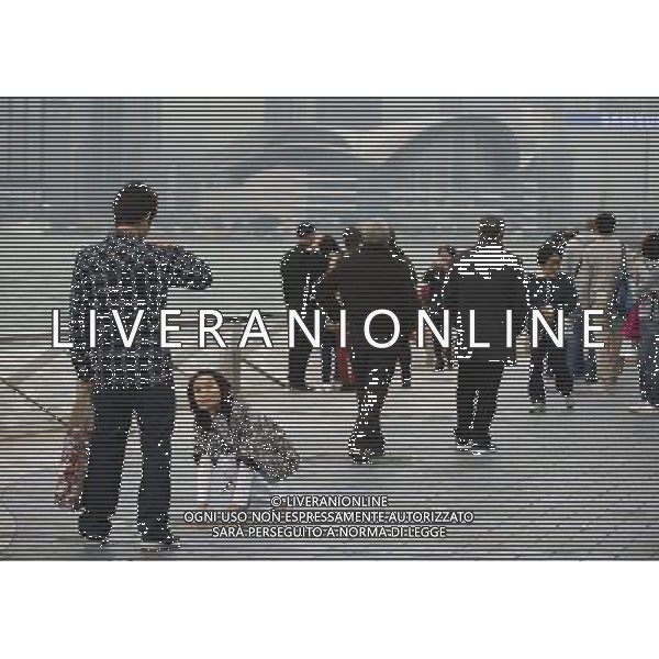 (120314) -- HONG KONG, March 14, 2012 () -- Tourists pose for photos at the Avenue of Stars in Hong Kong, south China, March 14, 2012. Hong Kong\'s visitor arrivals in package tours in February soared by 37.7 percent year on year to 9,204, and the total visitor arrivals in package tours in January and February add up to 17,761, according to figures released by the Travel Industry of Hong Kong Wednesday. (/Liu Sui Wai)