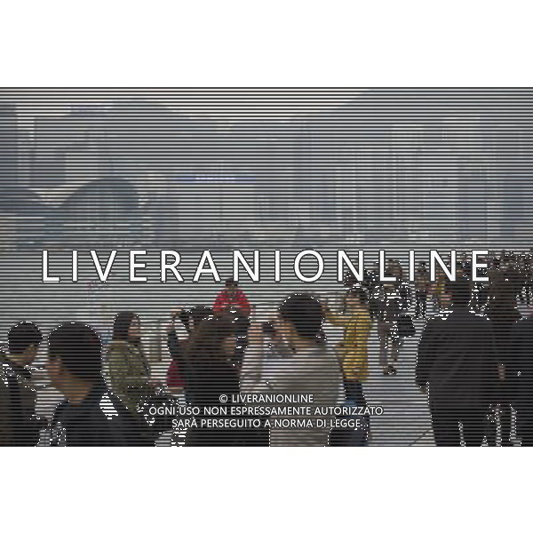 (120314) -- HONG KONG, March 14, 2012 () -- Tourists pose for photos at the Avenue of Stars in Hong Kong, south China, March 14, 2012. Hong Kong\'s visitor arrivals in package tours in February soared by 37.7 percent year on year to 9,204, and the total visitor arrivals in package tours in January and February add up to 17,761, according to figures released by the Travel Industry of Hong Kong Wednesday. (/Liu Sui Wai)