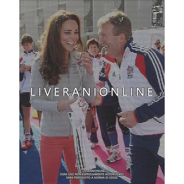 LONDON, ENGLAND - MARCH 15: Catherine, Duchess of Cambridge laughs as she talks to David Faulkner (performance director of GB hockey) at the Riverside Arena in the Olympic Park on March 15, 2012 in London, England. The Duchess of Cambridge viewed the Olympic park as well as meeting members of the men\'s and women\'s GB Hockey teams. ©photoshot/AGENZIA ALDO LIVERANI SAS - ITALY ONLY - REALI INGLESI: Kate Middleton, duchessa di Cambridge in visita al Parco Olimpico presso l\'Arena Riverside per incontrare i membri degli uomini e donne della squadra di hockey inglese - Londra, Inghilterra - 15 marzo 2012