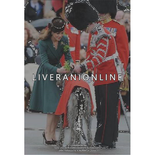 DUCHESS OF CAMBRIDGE - presents shamrocks to members of the 1st Battalion Irish Guards at the St Patrick\'s Day Parade, Mons Barracks, Aldershot on Saturday March 17 2012. 450 soldiers were on parade, accompanied by the regimental mascot Conmeal, an Irish wolfhound who received his own sprig of shamrock from the Duchess. This was her first solo military engagement and she will now inherit a tradition begun in 1901 by Queen Alexandra and more recently carried out for 32 years by the Queen Mother. Prince William is honorary Colonel of the Irish Guards. Kate Middleton, green dress, pillbox hat.NPA ROTA March 17 2012 ©photoshot/Agenzia Aldo Liverani Sas - ITALY ONLY - REALI INGLESI: Kate Middleton duchessa di Cambridge con il battaglione delle Guardie irlandesi durante la Parata del giorno di San Patrizio, Caserma Mons, Aldershot 17 Marzo 2012.