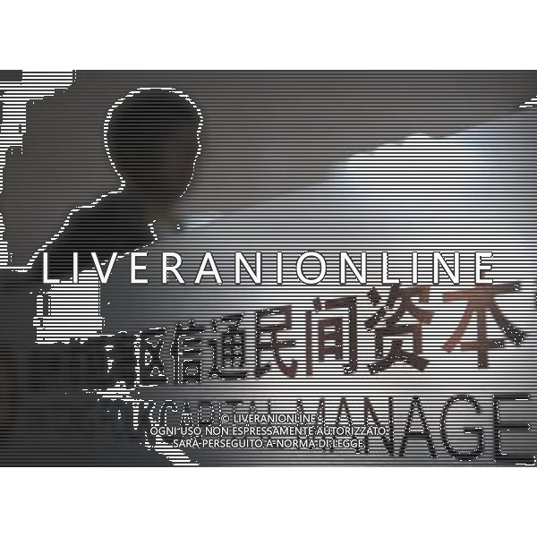 (120328) -- WENZHOU, March 28, 2012 () -- A person stands by a panel at Xintong folk capital management company in Wenzhou, east China\'s Zhejiang Province, March 28, 2012. China has approved plans to set up a pilot zone in the eastern city of Wenzhou to regulate private financing activities, the State Council said Wednesday. The long-awaited decision comes as underground private financing activities in Wenzhou, a major source of funding for the nation\'s small and medium-sized business, have stirred up heated financial disputes and crime and threatened financial and economic stability. Wenzhou, a place full of vibrant business activities, said on March 27, 2012 that the city\'s biggest financial problem lies in liquidity shortage, which is rooted in distrust among companies, banks, and authorities. Wenzhou came into the spotlight earlier last year after reports of cracks appearing in its vast underground lending market and surging bankruptcies. Effectively sorting out Wenzhou\'s problems and making financing serve the real economy are not only important for the healthy development of Wenzhou, but also of great pioneering significance for financial reform and economic development throughout the nation, according to a statement released after a State Council executive meeting presided over by Premier Wen Jiabao on March 28, 2012. (/Wang Dingchang) (zhs) ©photoshot/AGENZIA ALDO LIVERANI SAS - ITALY ONLY - Cina: Veduta della citta\' di Wenzhou, zona pilota per disciplinare le attivita\' di finanziamento privato e per le piccole e medie imprese della nazione, 27 marzo 2012