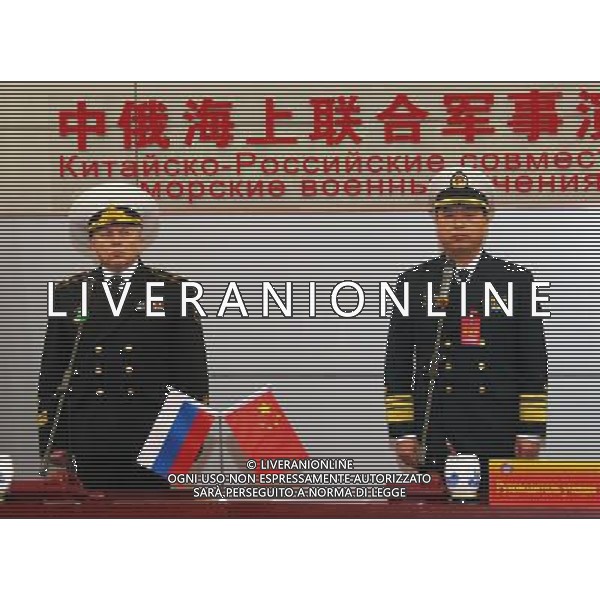 (120422) -- QINGDAO, April 22, 2012 () -- Ding Yiping (L), deputy commander of the Navy of the Chinese People\'s Liberation Army, and Rear Admiral Leonid Sukhanov (R), Russian naval deputy chief of staff, attend the starting ceremony of the Russia-China joint naval exercise in Qingdao, east China\'s Shandong Province, April 22, 2012. The Russia-China joint naval exercise, scheduled to be held from April 22 to 27 in the Yellow Sea of the Pacific Ocean, officially started on Sunday morning. The drill involves a total of 16 vessels and two submarines from the Chinese Navy and four warships from the Russian Navy\'s Pacific Fleet as well as three supply ships. The exercise will focus on joint maritime air defense and defense of marine traffic arteries, including subjects of joint escort, maritime search and rescue, anti-submarine tactics as well as joint effort to rescue hijacked vessels. (/Zha Chunming) (lfj) ©photoshot/AG ALDO LIVERANI SAS - ITALY ONLY -