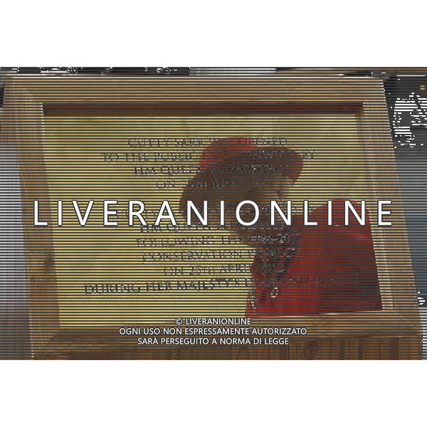 Britain\'s Queen Elizabeth II is seen reflected in a plaque after she unveiled it during a visit to the Cutty Sark in Greenwich, London, Wednesday, April 25, 2012. The Cutty Sark, built in 1869 was one of the last and one of the fastest tea clippers to be built. The Cutty Sark was badly damaged by fire on in May 2007 but after a 50 million pounds ($80.6 million) restoration project the vessel is restored and will reopen to the public on April 26, 2012 ©photoshot/AGENZIA ALDO LIVERANI SAS - ITALY ONLY - REALI INGLESI: Sua Maesta\' la Regina Elisabetta II d\'inghilterra in visita al Museo Nazionale della Marina
