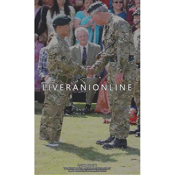 The Prince of Wales, presents a Service medal to Cpl Harri Bahadar Budah who lost both legs whilst serving in Afghanistan, during a visit to The First Battalion The Royal Gurkha Rifles at Sir John Moore Barracks, in Folkestone, Kent. ©photoshot/AGENZIA ALDO LIVERANI SAS - ITALY ONLY - REALI INGLESI: Carlo d\'inghilterra, Principe di Galles, durante una visita al primo battaglione The Rifles Gurkha Reali della caserma Sir John Moore, in Folkestone nel Kent. 