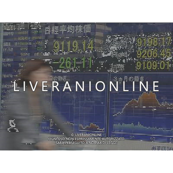 (120507) -- TOKYO, May 7, 2012 () -- A woman passes by an electronic stock board in Tokyo, Japan, May 7, 2012. Nikkei fell to a three-month closing low below 9,200 on Monday, following fresh European concern raised by French and Greek elections. The 225-issue Nikkei Stock Average ended down 261.11 points, or 2.78 percent, from Wednesday at 9,119.14, its lowest closing mark since Feb. 14, when it fell to 9,052.07. (/Kenichiro Seki) (zw) AG ALDO LIVERANI S A S ONLY ITALY