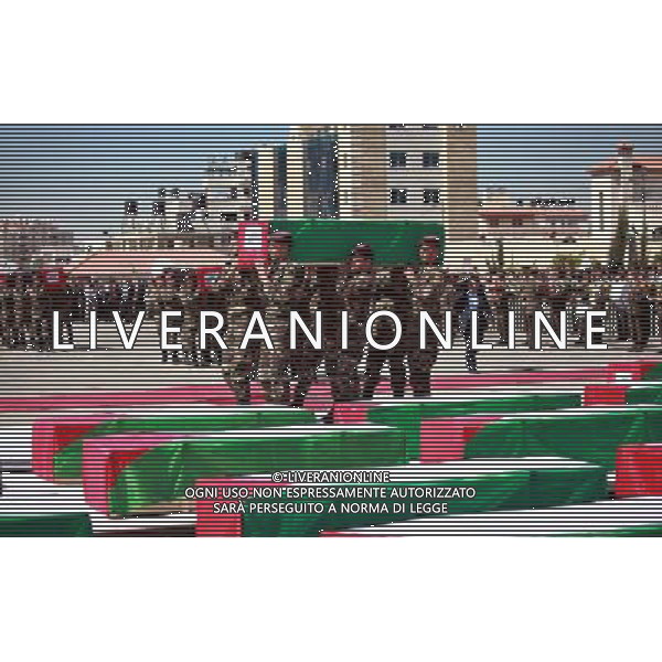 (120531) -- RAMALLAH, May 31, 2012 () -- Palestinian security members carry coffins during the funeral ceremony of 79 Palestinians after Israel handed over their remains, in the West Bank city of Ramallah, on May 31, 2012. Israel returned the remains of 91 Palestinian militants Thursday morning, and the bodies are on their way to the West Bank and Gaza, a Palestinian official said. (/Fadi Arouri) /PHOTOSHOT/AG ALDO LIVERANI SAS -ITALY ONLY - /PHOTOSHOT/AG ALDO LIVERANI SAS -ITALY ONLY -