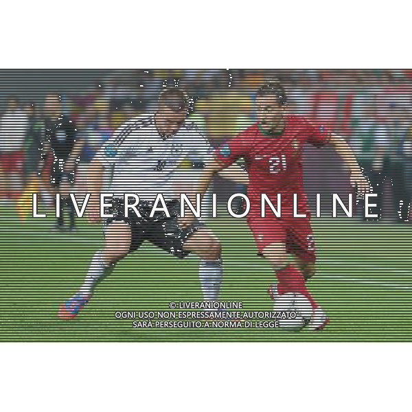 09.06.2012 LWOW - STADION ARENA LWOW ( LVIV UKRAINE STADIUM ARENA LVIV ) PILKA NOZNA ( FOOTBALL ) MISTRZOSTWA EUROPY W PILCE NOZNEJ UEFA EURO 2012 ( EUROPEAN CHAMPIONSHIPS UEFA EURO 2012 ) GRUPA B ( POOL B ) MECZ NIEMCY - PORTUGALIA ( GAME GERMANY - PORTUGAL ) NZ LUKAS PODOLSKI (L), JOAO PEREIRA (P) FOTO MICHAL STANCZYK / CYFRASPORT/NEWSPIX.PL --- Newspix.pl /Agenzia Aldo Liverani Sas - ITALY ONLY: Germania - Portogallo Campionati Europei UEFA 2012 Polonia/Ucraina Gruppo B Leopoli (Ucraina) 09/06/2012 *** Local Caption *** www.newspix.pl mail us: info@newspix.pl call us: 0048 022 23 22 222 --- Polish Picture Agency by Ringier Axel Springer Poland