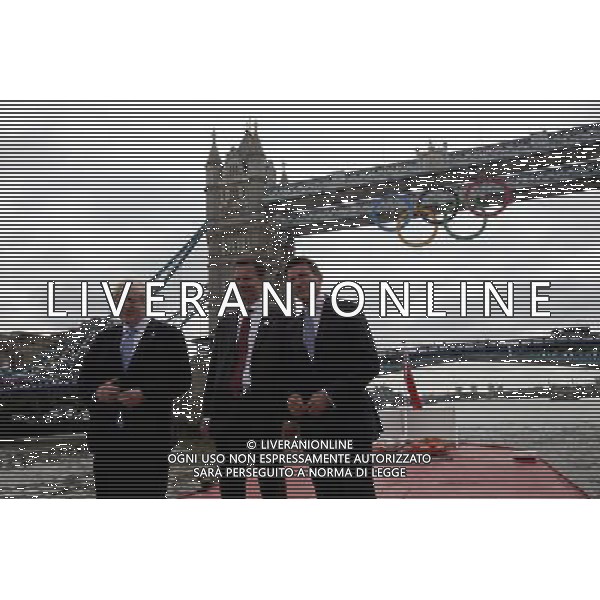 Mayor of London Boris Johnson (C) Lord Sebastian Coe, The Chair of the London Organising Committee of the Olympic Games and British Culture Secretary (R)Jeremy Hunt (L), poss for a photograph as a giant set of Olympic rings are displayed from Tower Bridge on June 27, 2012 in London, England. The rings weigh over three tonnes and measure over 25 metres wide by 11.5 metres tall; they will be illuminated in a light-show every evening during the Games. photoshot/AG ALDO LIVERANI SA - ITALY ONLY - *** Local Caption *** .