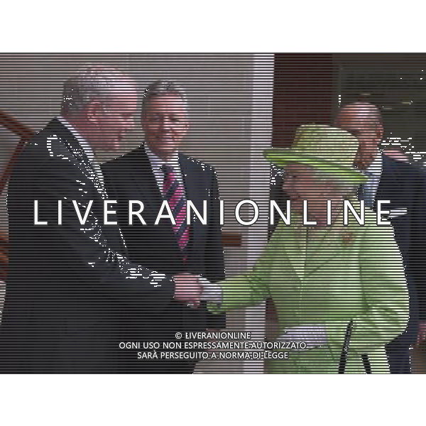 Queen Elizabeth II shakes hands with Northern Ireland Deputy First Minister Martin McGuinness watched by First minister Peter Robinson (centre) at the Lyric Theatre in Belfast. ©PHOTOSHOT/AG ALDO LIVERANI SAS - ITALY ONLY - 