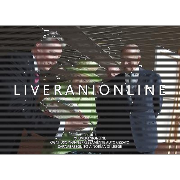 Queen Elizabeth II and the Duke of Edinburgh admire a gift held by Northern Ireland First Minister Peter Robinson and watched by Deputy First Minister Martin McGuinness (second left) at the Lyric Theatre in Belfast. ©PHOTOSHOT/AG ALDO LIVERANI SAS - ITALY ONLY - 