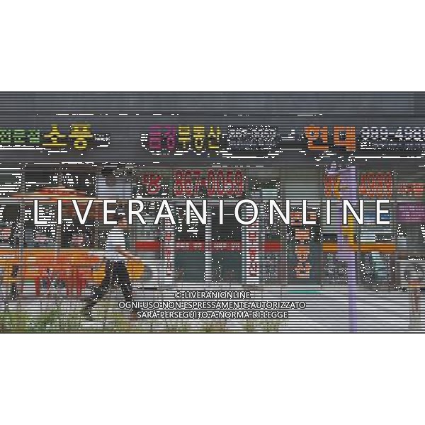 (120703) -- SEOUL, July 3, 2012 () -- A man walks past a real estate agency at a residential area in Sejong City, 120 kms south of Seoul, South Korea, July 3, 2012. South Korea on Monday officially launched a new administrative city, a source of partisan acrimony for the past decade. Sejong City will eventually house 36 government ministries and agencies by 2014. Its current population of 120,000 is projected to jump to 500,000 by 2030. (/Yao Qilin) ©photoshot/AGENZIA ALDO LIVERANI SAS - ITALY ONLY - Progetto di urbanizzazione della citta\' di Sejong, 120 km a sud di Seoul, Corea del Sud, 3 luglio 2012 che diventera\' una cittˆ amministrativa, con 36 ministeri e agenzie governative entro il 2014. La sua popolazione attuale di 120.000 abitanti salira\' a 500.000 entro il 2030.