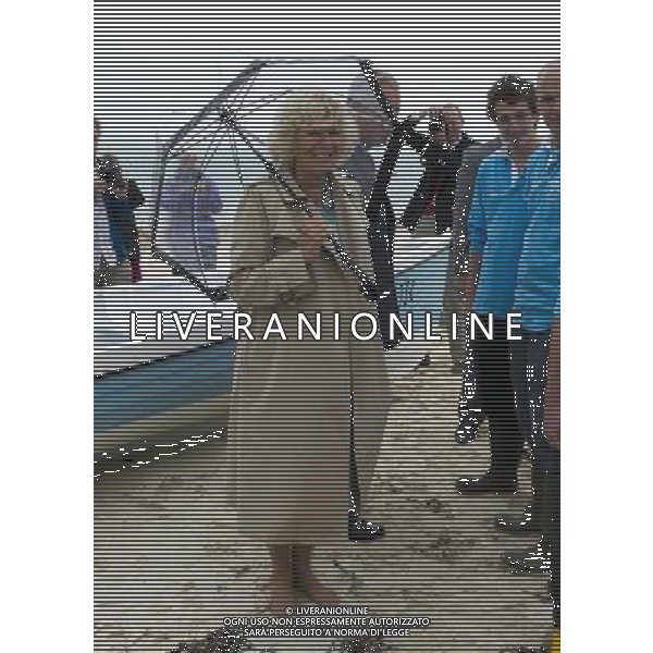 The Duke and Duchess of Cornwall met members of the Tresco and Bryher gig club and vieed the gig on the beach at the Sussex Gig Shed, Bryher, Isles of Scilly, THE DUCHESS STROLLS BAREFOOT ON THE BEACH TR23 0PR. PHOTOSHOT/AG ALDO LIVERANI SAS - ITALY ONLY -