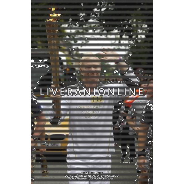 Former Olympian and Torchbearer Iwan Thomas carries the Olympic Flame on the Torch Relay leg between Newmarket and Cambridge. /PHOTOSHOT/AG ALDO LIVERANI SAS - ITALY ONLY -