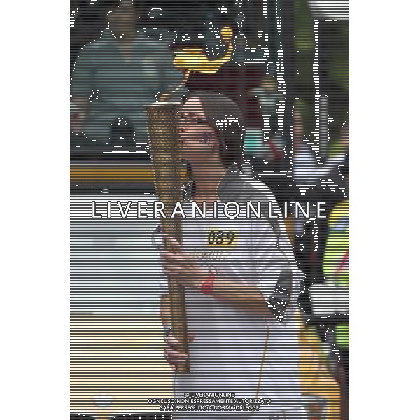 Torchbearer Claire Weston kisses her Olympic Flame torch on the Torch Relay leg between Hatfield and St Albans. /PHOTOSHOT/AG ALDO LIVERANI SAS - ITALY ONLY -