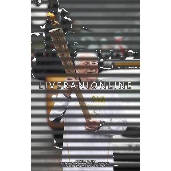 Torchbearer 017 William Whittaker carries the Olympic Flame on the Torch Relay leg between St Ives and Huntingdon. /PHOTOSHOT/AG ALDO LIVERANI SAS - ITALY ONLY -