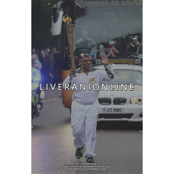 Torchbearer 022 Queens Park Rangers Chairman Tony Fernandes carries the Olympic Flame on the Torch Relay leg between St Ives and Huntingdon. /PHOTOSHOT/AG ALDO LIVERANI SAS - ITALY ONLY -