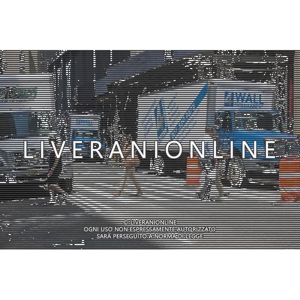 Pedestrians cross on Six and one-half Avenue in Midtown Manhattan in New York on Friday, July 6, 2012. The new street is actually a series of interconnected pedestrian arcades, mid-block between Sixth and Seventh Avenues, running from West 51 Street to West 57 Street. The city is in the process of installing signage and pedestrian crossings. Up to 1200 people an hour use the connected arcades to travel through midtown. The arcades are privately owned public spaces that are provided by the buildings\' owners in exchange for zoning variances. (å Richard B. Levine) /PHOTOSHOT/AG ALDO LIVERANI SAS - ITALY ONLY -