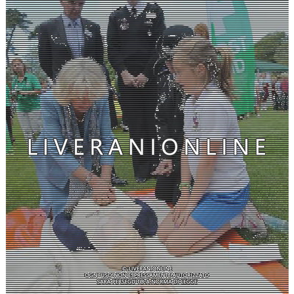 GUERNSEY, GUERNSEY - JULY 19: Camilla, Duchess of Cornwall learns how to perform resuscitation with the St John\'s Ambulance as she takes part in a Youth Showcase during a visit to Saumarez Park on July 19, 2012 in St Peter\'s Port, United Kingdom. The Prince of Wales and the Duchess of Cornwall are in Jersey as part of a Diamond Jubilee visit to the Channel Islands taking in Jersey, Guernsey and Sark ©photoshot/AGENZIA ALDO LIVERANI SAS - ITALY ONLY - REALI INGLESI: Il principe Carlo d\'inghilterra e la moglie Camilla in visita alle Isole Normanne. 