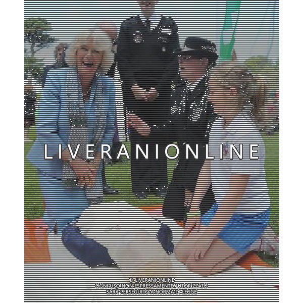 GUERNSEY, GUERNSEY - JULY 19: Camilla, Duchess of Cornwall learns how to perform resuscitation with the St John\'s Ambulance as she takes part in a Youth Showcase during a visit to Saumarez Park on July 19, 2012 in St Peter\'s Port, United Kingdom. The Prince of Wales and the Duchess of Cornwall are in Jersey as part of a Diamond Jubilee visit to the Channel Islands taking in Jersey, Guernsey and Sark ©photoshot/AGENZIA ALDO LIVERANI SAS - ITALY ONLY - REALI INGLESI: Il principe Carlo d\'inghilterra e la moglie Camilla in visita alle Isole Normanne. 