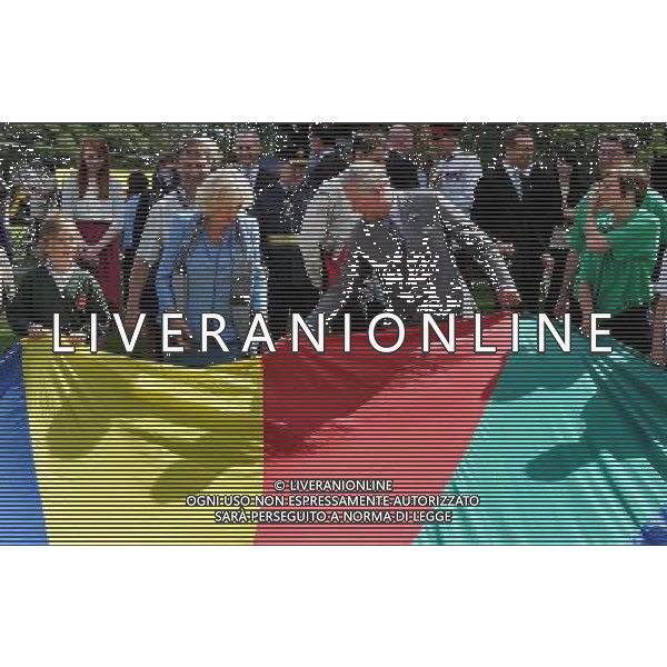 The Prince of Wales and the Duchess of Cornwall hold a brightly coloured Parachute with scouts and Girl Guides, during a youth rally at Saumarez Park in Guernsey, as they continue their visit to the Channel Islands. ©photoshot/AGENZIA ALDO LIVERANI SAS - ITALY ONLY - REALI INGLESI: Il principe Carlo d\'inghilterra e la moglie Camilla in visita alle Isole Normanne. 