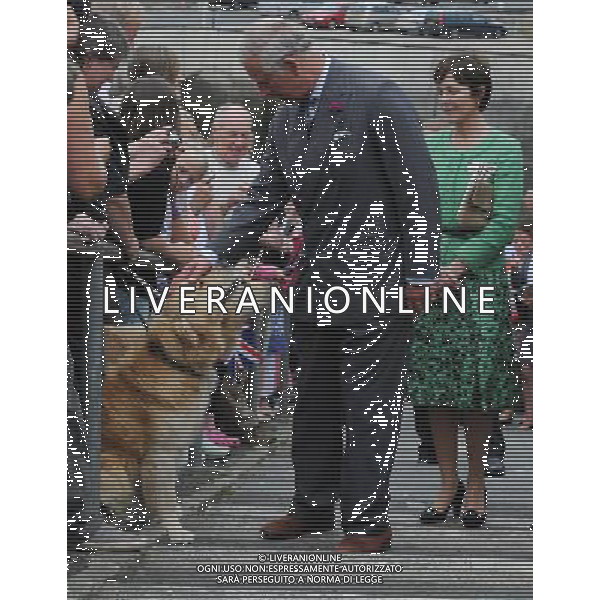 The Prince of Wales greets two labradors as he visits Seahouses, Northumberland during the second day of his tour of the North-east. Tuesday July 24, 2012. ©photoshot/Agenzia Aldo Liverani Sas - ITALY ONLY - REALI INGLESI: Il Principe Carlo d\'inghilterra durante la visita nel nord-est 23 luglio 2012.