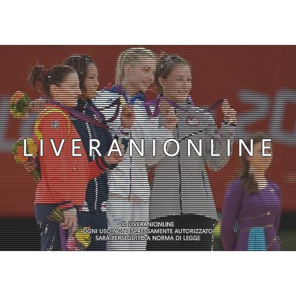 (120730) -- LONDON, July 30, 2012 () -- Gold medalist Kaori Matsumoto of Japan (2nd L), silver medalist Corina Caprioriu of Romania (1st L), and bronze medalists Marti Malloy of the United States (1st R) and Automne Pavia of France pose at the awarding ceremony of women\'s 57kg judo event at London 2012 Olympic Games, London, Britain, July 30, 2012. (/Chen Xiaowei) AG ALDO LIVERANI S A S ONLY ITALY