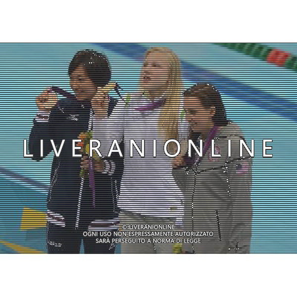 (120730) -- LONDON, July 30, 2012 () -- Gold medalist Ruta Meilutyte of Lithuania (C), silver medalist Rebecca Soni of USA (R) and bronze medalist Satomi Suzuki of Japan pose for pictures during victory ceremony of women\'s swimming 100m breaststroke contest, at London 2012 Olympic Games in London, Britain, on July 30, 2012. (/Li Gang) (nxl) AG ALDO LIVERANI S A S ONLY ITALY