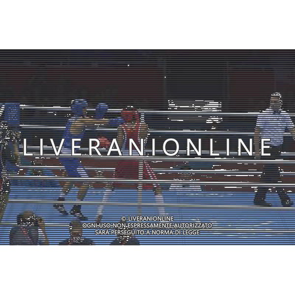 Anderson Rojas Mina (Red) from Ecuador seen against Uktamjon Rahmonov (Blue) from Uzbekistan seen during Men\'s Light Welter (64kg) Mens Boxing London 2012 Olympic Games held at the Excel. London /ALDO LIVERANI SAS-ITALY ONLY - EDITORIAL USE ONLY