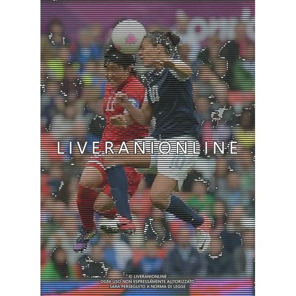 (120731) -- LONDON, July 31, 2012 () -- Kim Chung Sim (L) of the Democratic People\'s Republic of Korea competes with Carli Lloyd of USA during women\'s football preliminary round group G match between the United States and the Democratic People\'s Republic of Korea, at London 2012 Olympic Games in Manchester, Britain, on July 31, 2012. The United States won 1-0. (/Wang Qingqin) (nxl) /ALDO LIVERANI SAS-ITALY ONLY - EDITORIAL USE ONLY
