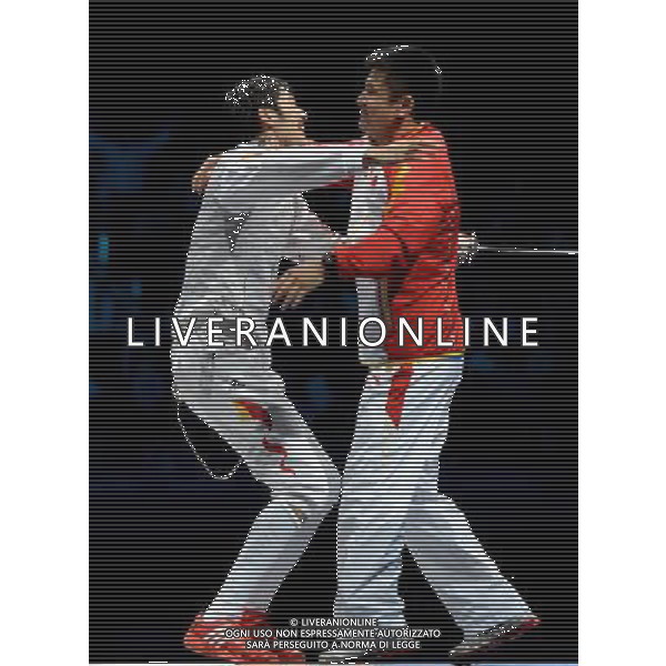 (120731) -- LONDON, July 31, 2012 () ¬C Lei Sheng of China (L) hugs his coach Wang Haibin after defeating Alaaeldin Abouelkassem of Egypt in men\'s fencing Foil individual gold medal match, at London 2012 Olympic Games in London, Britain, on July 31, 2012. (/Wang Yuguo) (nxl) /ALDO LIVERANI SAS-ITALY ONLY - EDITORIAL USE ONLY