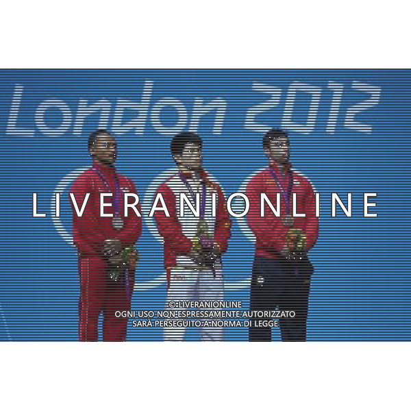 (120731) -- LONDON, July 31, 2012 () -- Lin Qingfeng (C) of China, Triyatno Triyatno (L) of Indonesia, and Razvan Constantin of Romania attend the awarding ceremony of men\'s weightlifting 69kg competition at London 2012 Olympic Games in London, Britain, July 31, 2012. Lin Qingfeng won the gold medal. (/Chen Jianli) (zgp) /ALDO LIVERANI SAS-ITALY ONLY - EDITORIAL USE ONLY