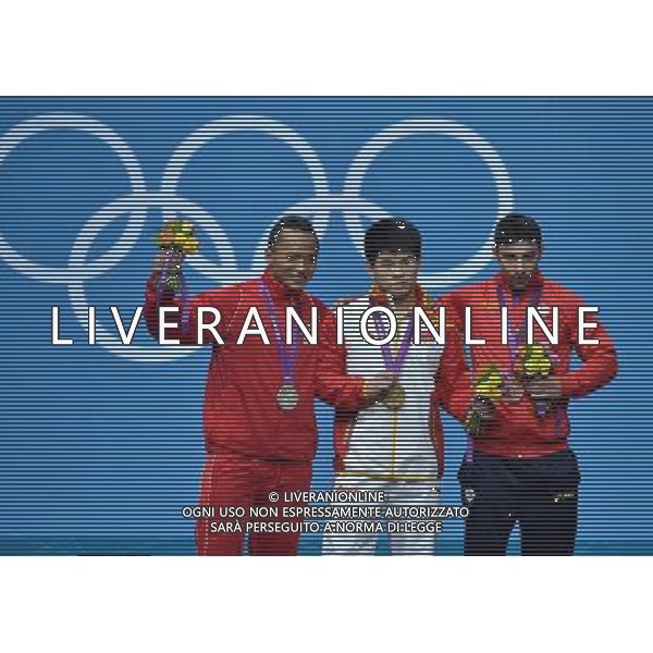 (120731) -- LONDON, July 31, 2012 () -- Lin Qingfeng (C) of China, Triyatno Triyatno (L) of Indonesia, and Razvan Constantin of Romania attend the awarding ceremony of men\'s weightlifting 69kg competition at London 2012 Olympic Games in London, Britain, July 31, 2012. Lin Qingfeng won the gold medal. (/Gong Lei) (zgp) /ALDO LIVERANI SAS-ITALY ONLY - EDITORIAL USE ONLY