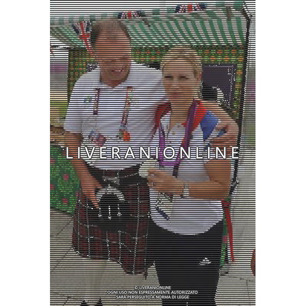 Alistair Dobson with Zara Philips an Olympic Silver winning rider from the GB Equestrian team, shows him her Medal when she stopped by at the taste of Scotland stand in the Olympic Athletes village, in Stratford east London. /ALDO LIVERANI SAS-ITALY ONLY - EDITORIAL USE ONLY