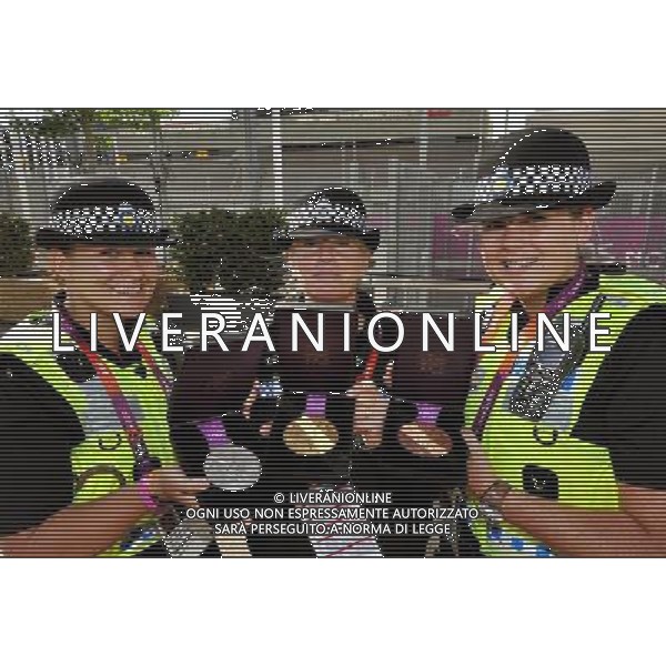 (left to right) Police Officers Jeni Harris, Sandra Ivens, and Christine Radford from the Gwent Police force, hold the Olympic Gold, Silver and Bronze Medals, during the Village Mayors trip around the Olympic Athletes village, in Stratford east London. /PHOTOSHOT/ALDO LIVERANI ITALY ONLY -