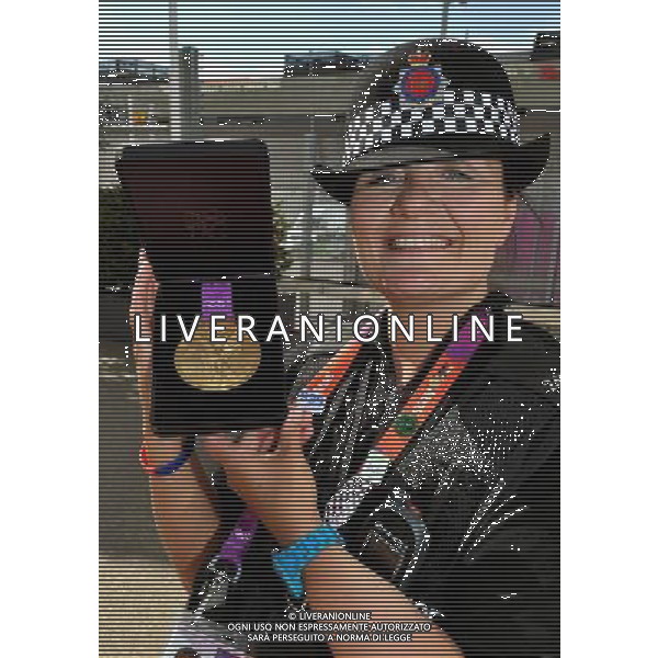 Police Officer Linda Gavin from the Manchester Police force holds the Olympic Gold Medal, during the Village Mayors trip around the Olympic Athletes village, in Stratford east London. /PHOTOSHOT/ALDO LIVERANI ITALY ONLY -