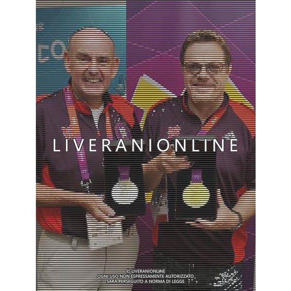 The Mayor of the Olympic Athletes village Sir Charles Allen shows comedian Eddie Izzard the Gold and Silver Medals, during his trip to the Olympic Athletes village, in Stratford east London. /PHOTOSHOT/ALDO LIVERANI ITALY ONLY -