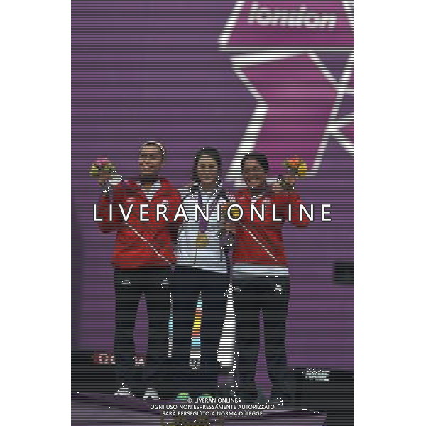 (120802) -- LONDON, Aug. 2, 2012 () -- Gold medalist Ki Bo Bae (C) of South Korea, silver medalist Aida Roman (L) of Mexico and bronze medalist Mariana Avitia of Mexico pose at the awarding ceremony of women\'s individual of archery event, at London 2012 Olympic Games in London, Britain, August 2, 2012. Ki Bo Bae won the gold medal. (/Gesang Dawa) (zgp) /PHOTOSHOT/ALDO LIVERANI ITALY ONLY -