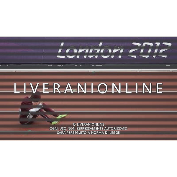 (120803) -- LONDON, Aug. 3, 2012 () -- Noor Hussain Al-Malki of Qatar rests after injury during women\'s 100m heat of athletics at London 2012 Olympic Games in London, Britain, August 3, 2012. Noor Hussain Al-Malki quitted the competition due to injury. (/Li Ming) (zgp) ©PHOTOSHOT/Agenzia Aldo Liverani Sas - ITALY ONLY - GIOCHI OLIMPICI, OLIMPIADI LONDRA 2012