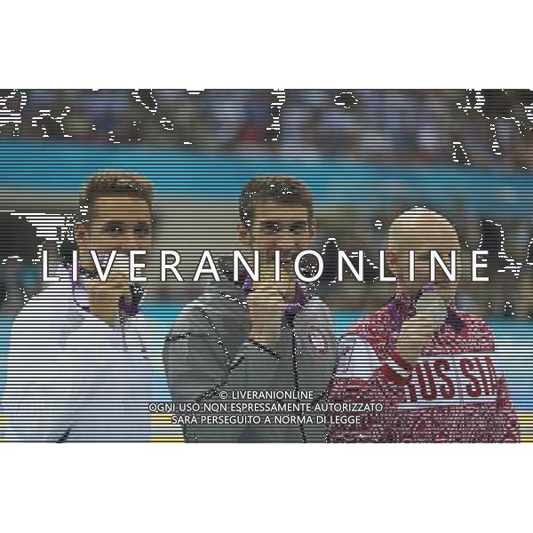 (120803) -- LONDON, Aug. 3, 2012 () -- Gold medalist Michael Phelps (C) of U.S., silver medalist Chad le Clos (L) of South Africa, Bronze medalist Evgeny Korotyshkin of Russia attend awarding ceremony of men¡¯s 100m butterfly of swimming competition, at London 2012 Olympic Games in London, Britain, August 3, 2012. (/Fei Maohua) (zgp) ©PHOTOSHOT/Agenzia Aldo Liverani Sas - ITALY ONLY - GIOCHI OLIMPICI, OLIMPIADI LONDRA 2012