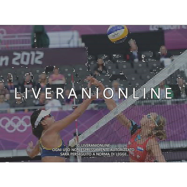 (120804) -- LONDON, Aug. 4, 2012 () -- Xue Chen of China (L) blocks the ball during round of 16 match of women\'s beach volleyball between Zhang Xi/Xue Chen of China and Ekaterina Khomyakova/Evgeniya Ukolova of Russia at London 2012 Olympic Games, London, Britain, Aug. 4, 2012.. Zhang Xi/Xue Chen of China won the match and advanced to the next round. (/Zeng Yi) ©PHOTOSHOT/Agenzia Aldo Liverani Sas - ITALY ONLY - GIOCHI OLIMPICI, OLIMPIADI LONDRA 2012