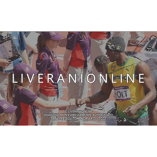 (120804) -- LONDON, Aug. 4, 2012 () -- Usain Bolt (R, front) of Jamaica talks with a staff member before the men\'s 100m round 1 heats at London 2012 Olympic Games, London, Britain, Aug. 4, 2012. Usain Bolt was qualified for the semifinal with a time of 10.09 seconds. (/Li Ming) ©PHOTOSHOT/Agenzia Aldo Liverani Sas - ITALY ONLY - GIOCHI OLIMPICI, OLIMPIADI LONDRA 2012