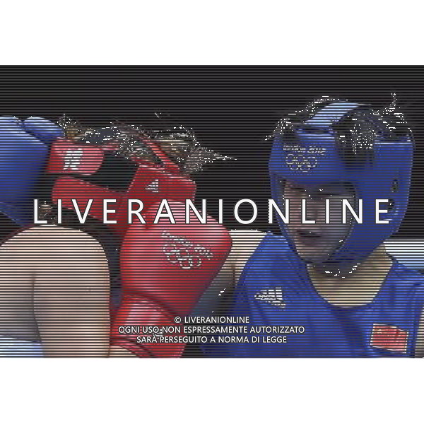 (120805) -- LONDON, Aug. 5, 2012 () -- Li Jinzi of China (blue) competes with Roseli Feitosa of Brazil during the round of 16 match of women\'s Middle (75kg) of Boxing event at London 2012 Olympic Games, London, Britain, Aug. 5, 2012. Li Jinzi won the match 19-14. (/Wang Shen) /PHOTOSHOT/AG ALDO LIVERANI SAS - ITALY ONLY -
