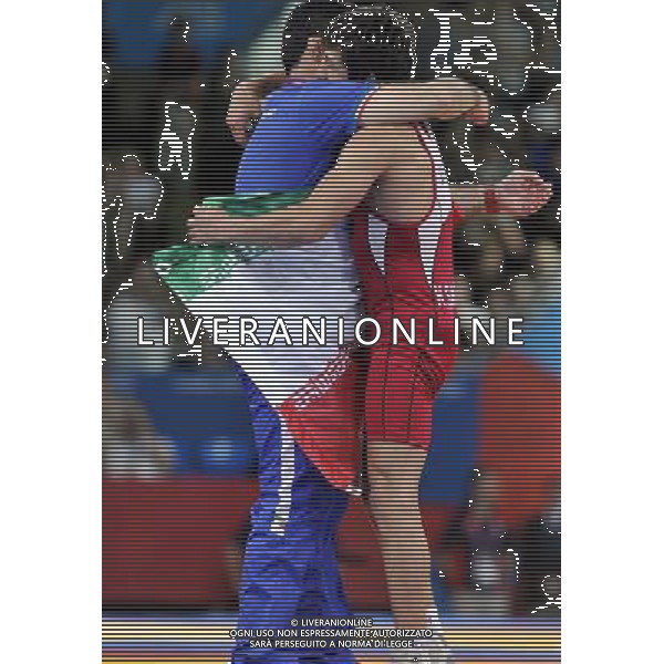(120805) -- LONDON, Aug. 5, 2012 () -- Hamid Mohammad Soryan Reihanpour of Iran (in red) is congratulated after defeating Rovshan Bayramov of Azerbaijan during men\'s wrestling greco-roman 55kg gold medal contest, at London 2012 Olympic Games in London, Britain, on August 5, 2012. Hamid Mohammad Soryan Reihanpour of Iran won the gold medal of the event. (/Gesang Dawa) /PHOTOSHOT/AG ALDO LIVERANI SAS - ITALY ONLY -