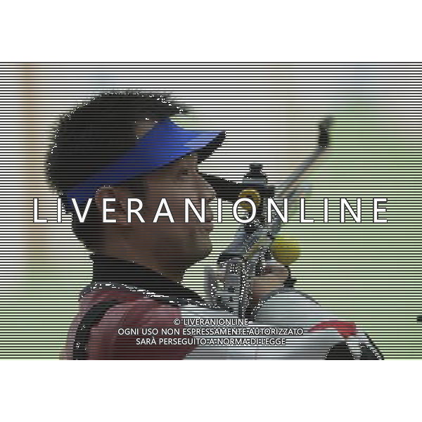 (120806) -- LONDON, Aug. 6, 2012 () -- Zhu Qinan of China acts during the qualification match of men\'s 50m rifle 3 positions of Shooting event at London 2012 Olympic Games, London, Britain, Aug. 6, 2012. Zhu Qinan was qualified for the final of the event with a score of 1170. (/Zeng Yi) AG ALDO LIVERANI S A S ONLY ITALY