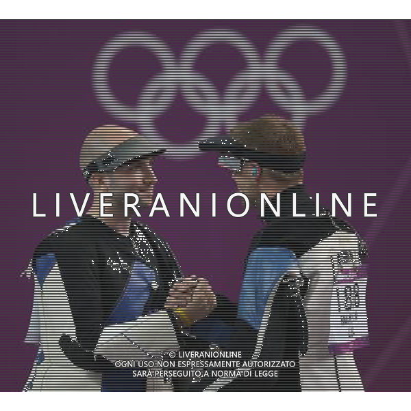 (120806) -- LONDON, Aug. 6, 2012 () -- Niccolo Campriani (L) of Italy receives congratulation from Matthew Emmons of the United States after men\'s 50m rifle 3 positions final of shooting at London 2012 Olympic Games, London, Britain, Aug. 6, 2012. Niccolo Campriani of Italy won gold medal and set a new Olympic record with 1278.5 in this event. (/Wang Lili)(zgp) AG ALDO LIVERANI S A S ONLY ITALY