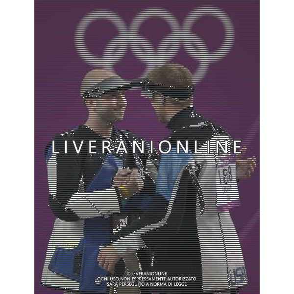 (120806) -- LONDON, Aug. 6, 2012 () -- Niccolo Campriani (L) of Italy hugs Matthew Emmons of the United States after men\'s 50m rifle 3 positions final of shooting at London 2012 Olympic Games, London, Britain, Aug. 6, 2012. Niccolo Campriani of Italy won gold medal and set a new Olympic record with 1278.5 in this event. (/Wang Lili)(zgp) AG ALDO LIVERANI S A S ONLY ITALY