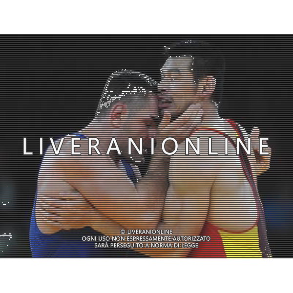(120806) -- LONDON, Aug. 6, 2012 () -- Liu Deli of China (in red) competes with Mihaly Beak-Bardos of Hungary during men\'s wrestling greco-roman 60kg qualifications contest, at London 2012 Olympic Games in London, Britain, on August 6, 2012. Mihaly Beak-Bardos of Hungary won. (/Li Gang) (nxl) AG ALDO LIVERANI S A S ONLY ITALY