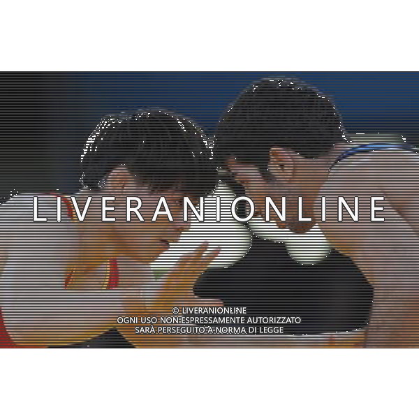 (120805) -- LONDON, Aug. 5, 2012 () -- Sheng Jiang of China (in red) competes with Omid Haji Noroozi of Iran during men\'s wrestling greco-roman 60kg qualifications match, at London 2012 Olympic Games in London, Britain, on August 6, 2012. Omid Haji Noroozi of Iran won. (/Li Gang) (nxl) AG ALDO LIVERANI S A S ONLY ITALY