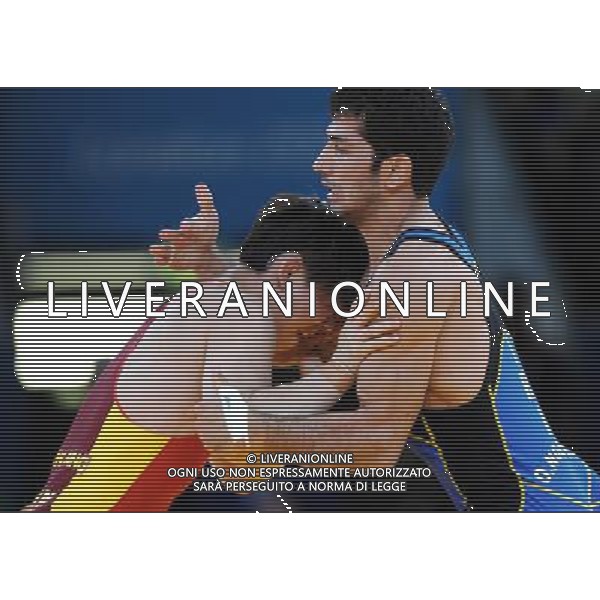 (120805) -- LONDON, Aug. 5, 2012 () -- Sheng Jiang of China (in red) competes with Omid Haji Noroozi of Iran during men\'s wrestling greco-roman 60kg qualifications match, at London 2012 Olympic Games in London, Britain, on August 6, 2012. Omid Haji Noroozi of Iran won. (/Li Gang) (nxl) AG ALDO LIVERANI S A S ONLY ITALY